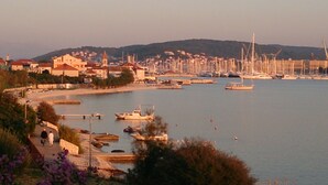 A coastal town with a marina, boats, and buildings along the waterfront. - Gem of the Sea Alenka (Seget)
