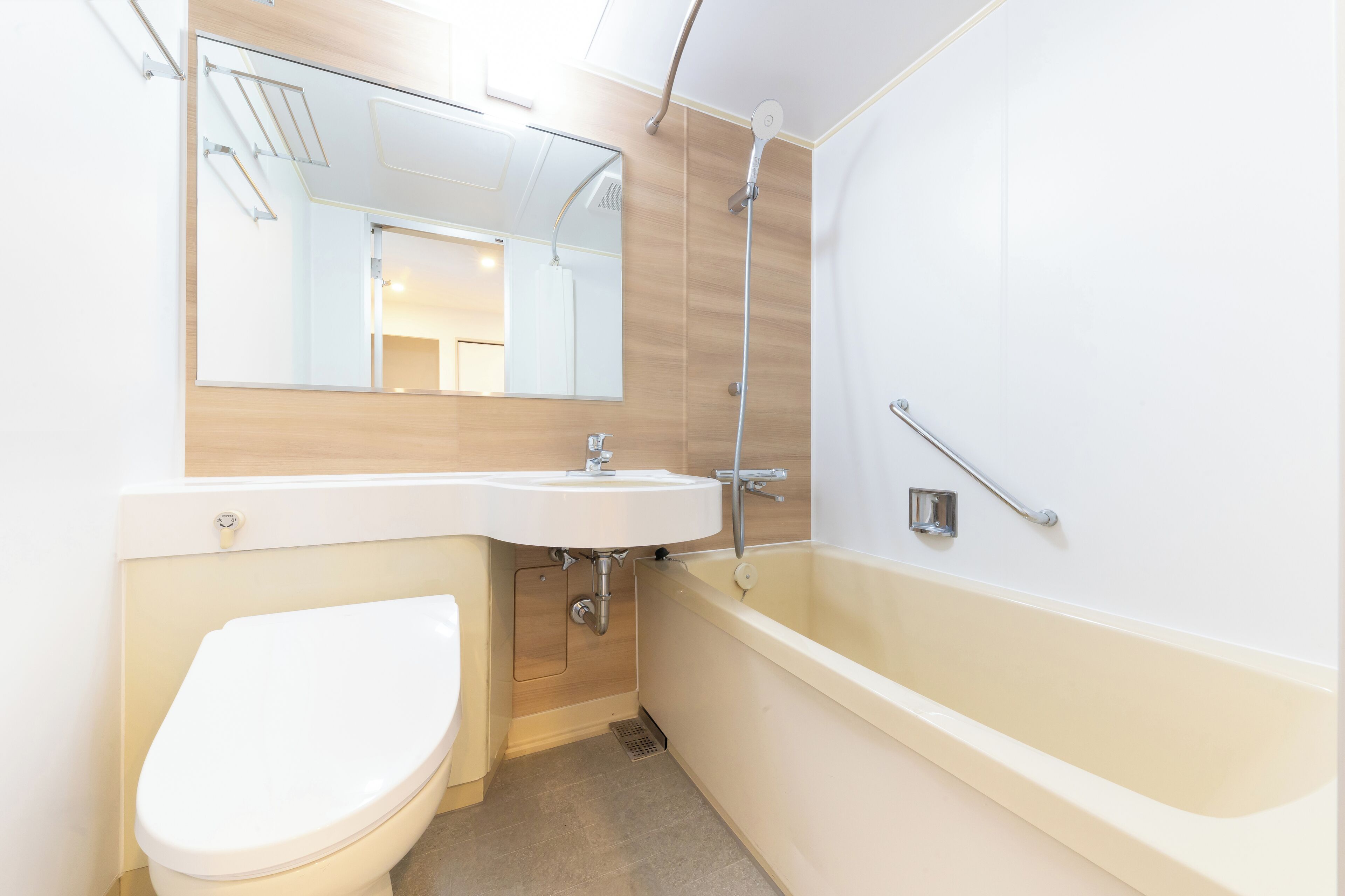A modern bathroom with a toilet, sink, and bathtub.