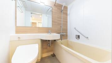 A modern bathroom with a toilet, sink, and bathtub.