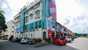 A hotel with multiple floors, large windows, and a prominent 'HOTEL' sign. - OYO 89877 Sun Triang Hotel (Teriang)