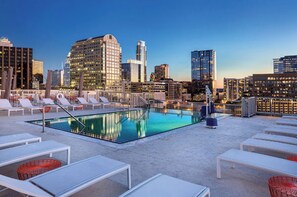 Relax by the rooftop pool with a stunning city view.