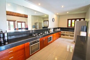 Enjoy cooking in this well-equipped kitchen with a refrigerator, oven, and microwave.