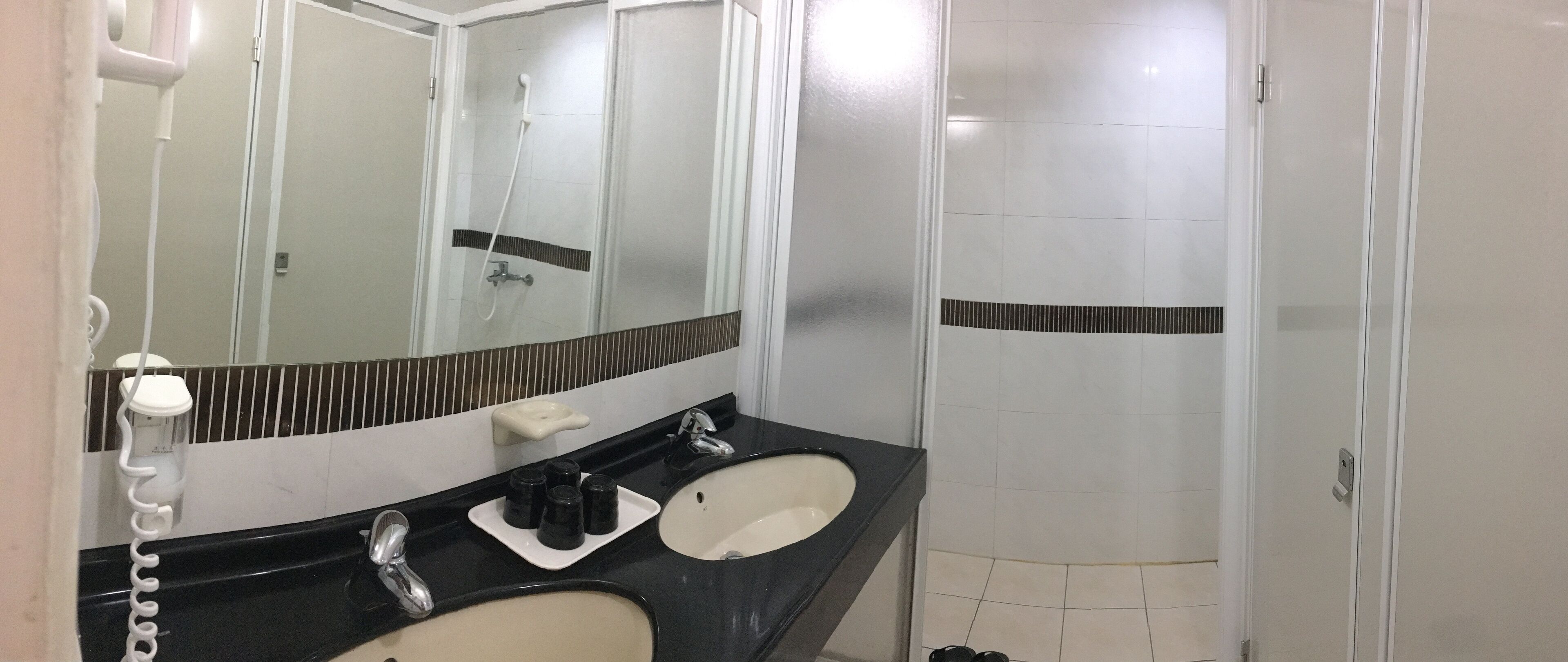 shower, hair dryer, slippers, towels