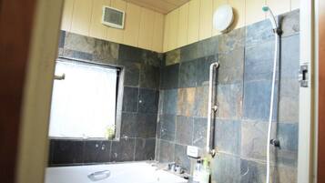 Combined shower/tub, hair dryer, slippers, towels
