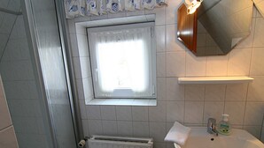 A bathroom with a window, a sink, a mirror, and a towel. - House Gräpel App. 5, Germany (Hörnum (Sylt))