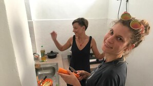 A kitchen with a sink, a cutting board, and a bottle of oil. - B&L Islanders Inn - Hostel (George Town)