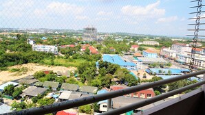 A view of a residential area with various buildings, including a construction site in the distance. - High Floor Apartment at Angket (Pattaya)