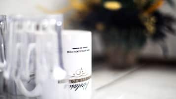 Two white mugs with text on them, placed on a table.