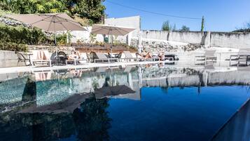 Seasonal outdoor pool, open 10:00 AM to 9:00 PM, pool loungers