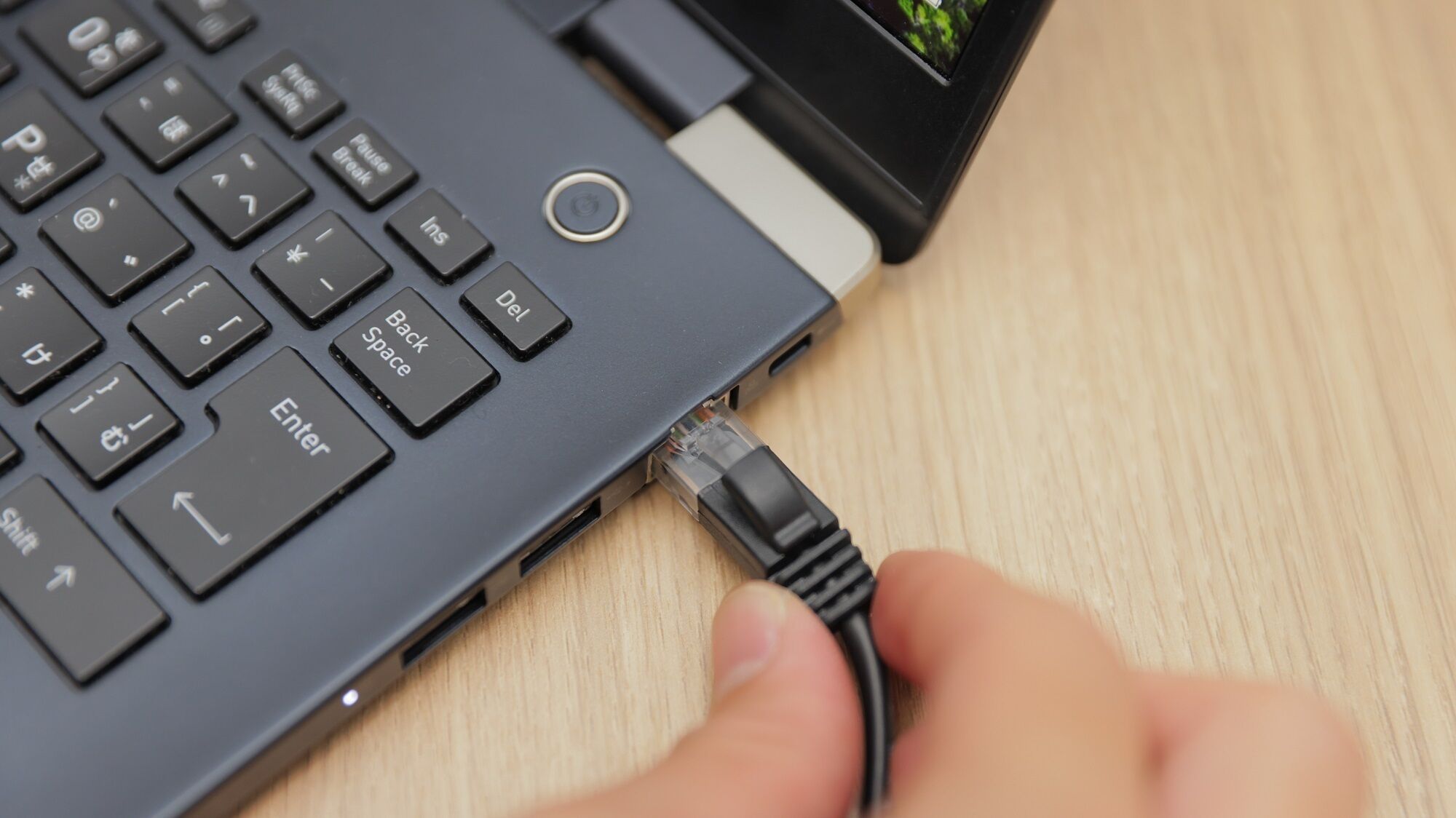 A laptop with a USB cable connected to it.