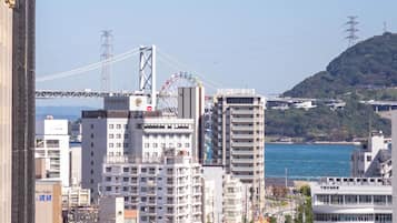 A cityscape with modern buildings, a bridge, and a body of water.