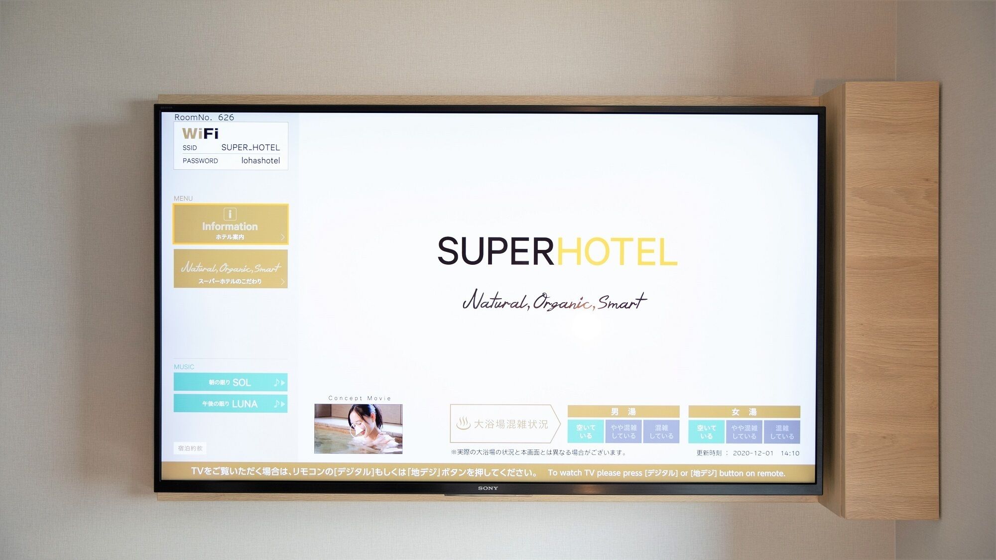 Une chambre d’hôtel avec un téléviseur affichant le site web de SUPERHOTEL, un cadre en bois et un meuble pour téléviseur fixé au mur.