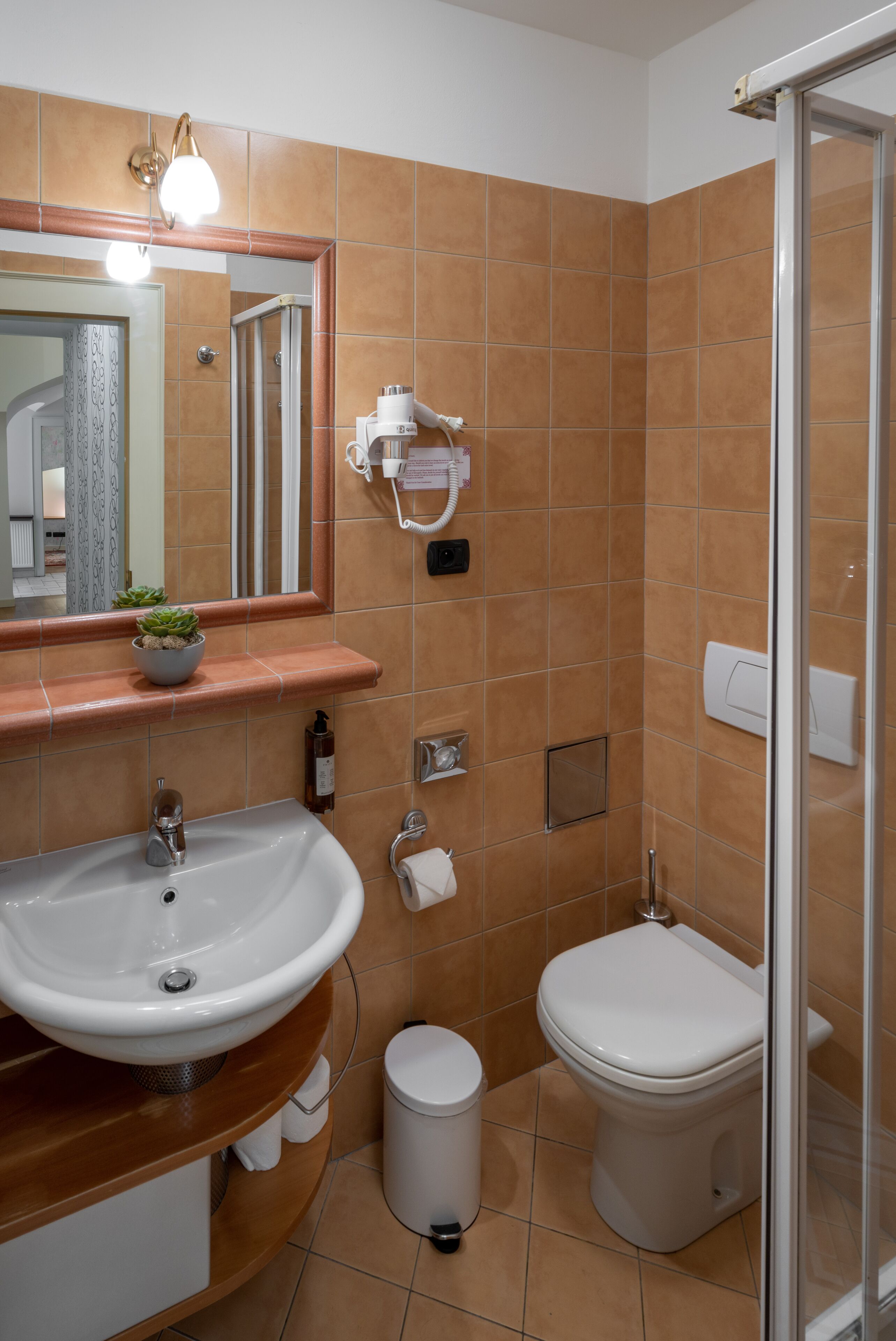 A bathroom with a sink, mirror, towel rack, and toilet.