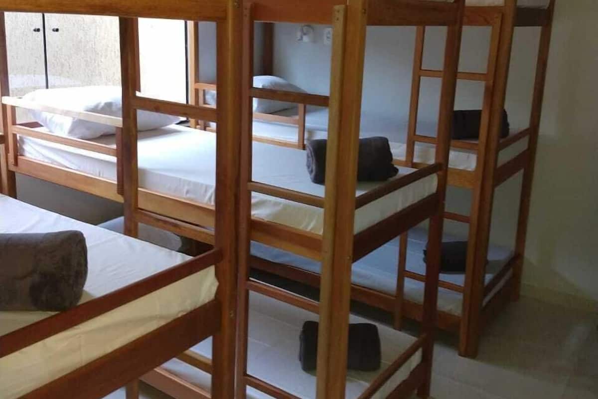 A room with bunk beds arranged in a row.