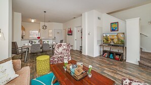 A spacious living room with a sofa, coffee table, and a TV area with bookshelves. - Newly Renovated, Spacious 3bd/2.5ba Villa With Lake View, Near Disney #3tv709 (Kissimmee)