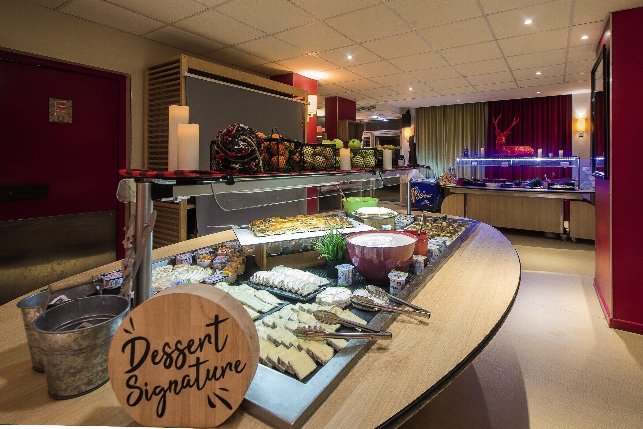 A buffet area with various desserts and a 'Dessert Signature' sign.