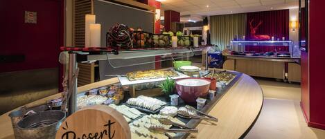 A buffet area with various desserts and a 'Dessert Signature' sign.
