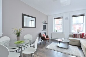 City Apartment (2 Bedrooms) | Living room | 24-inch TV with digital channels, DVD player, books