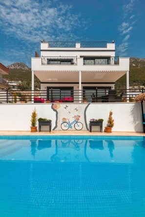 Outdoor pool, a heated pool, pool loungers