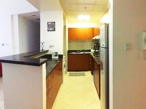 Fridge, microwave, oven, stovetop - Octavius Holiday Home, Large 2 BR Apt near Global Village & Dubai Outlet Mall (Dubai)