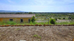 A building with a tiled roof and a view of a rural landscape. - Residence a Badesi ID 3372 (Badesi)