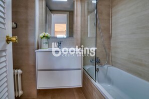 Bathtub, towels, soap, toilet paper