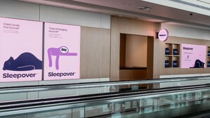 A Sleepover store with promotional posters and a visible entrance. - Sleepover Terminal 1, Concourse D – formerly sleep ‘n fly (Dubai)