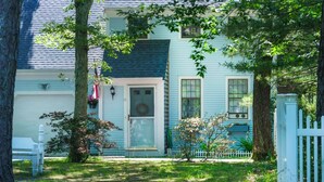 A two-story house with a front porch, a mailbox, and a small garden. - Cape Cod retreat , vacation memorable beaches , Good for families . (Barnstable)