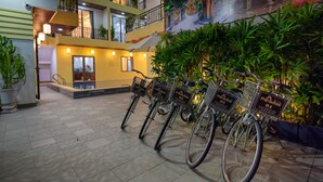 A multi-level hotel lobby with tiled floors, a staircase, and a mural depicting a street scene. - Hoi An Paradise Villa (Da Nang)