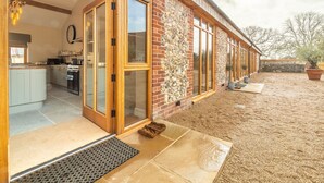 A modern house with a spacious kitchen, large sliding glass doors, and a well-maintained backyard. - Red Stag Lodge, Little Massingham, Norfolk (Little Massingham)