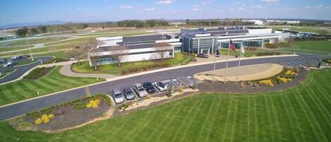 A modern building with a parking lot and landscaped areas.