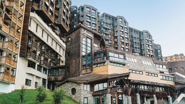 A multi-story building with a wooden facade and balconies, a stone base, and a sign reading "Belambra." - Belambra Clubs Avoriaz - Les Cimes du Soleil  (Morzine)