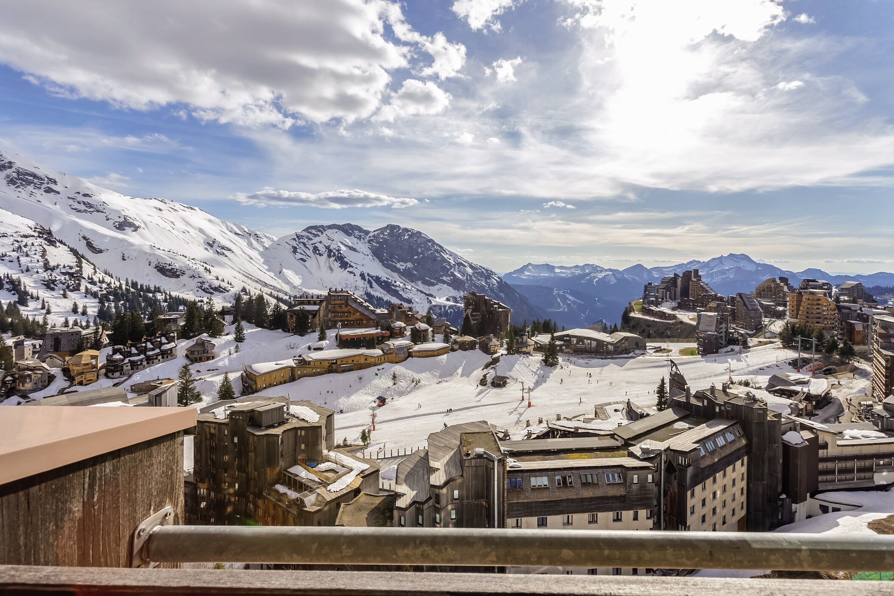 Une ville de montagne enneigée, avec des bâtiments historiques et une piste de ski.