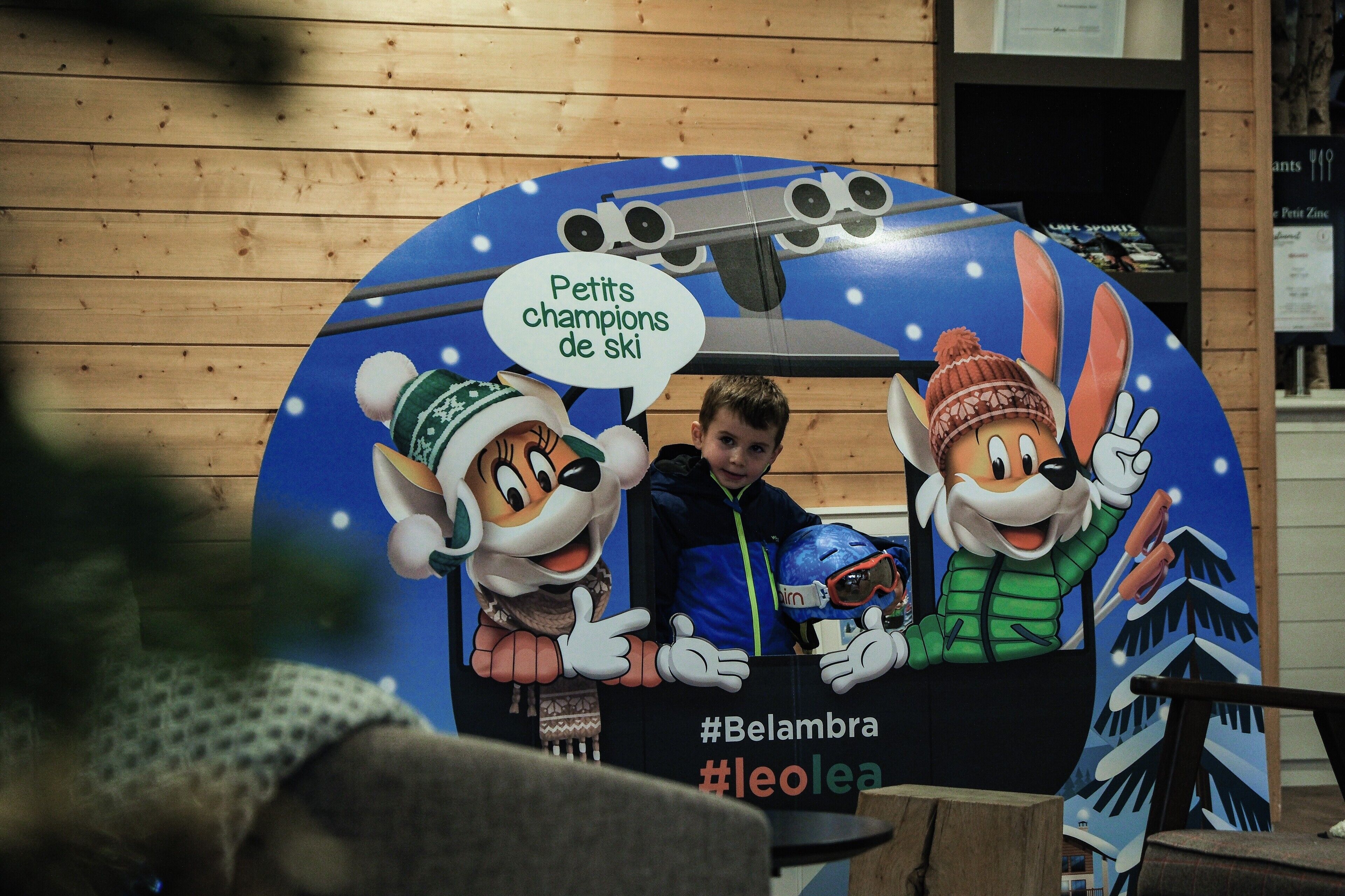 A ski-themed display with cartoon characters and a sled, featuring hashtags #Belambra and #leolea.