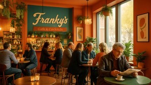A cozy cafe with tables and chairs, a bar area, and hanging plants. - Apartment Osterstraße 347 (Hannover)