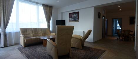 Deluxe Condo | Living area | Flat-screen TV