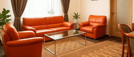 Deluxe Condo | Living area | Flat-screen TV