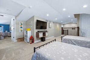 Cozy retreat with a bed, desk, and shelving unit, perfect for relaxation and productivity.