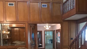 A spacious living room with two sofas, a chandelier, and a staircase leading to an upper level. - El Castillo (The Castle) (McAllen)