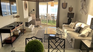 A modern living room with a glass coffee table, a beige sofa, a dining table, and a view of the ocean through large windows. - BEACHFRONT APARTMENT IN FUENGIROLA (Fuengirola)