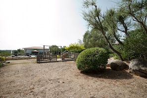 Enjoy a serene outdoor setting with a beautifully maintained lawn and lush greenery.