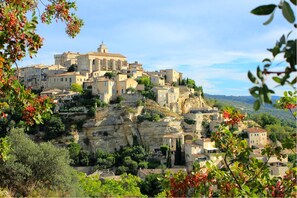 Traditional stone buildings line the hillside, blending seamlessly into the surrounding landscape.