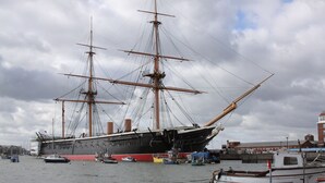 A large sailing ship docked at a harbor with smaller boats nearby. - College Street Abode - Guest House (Portsmouth)