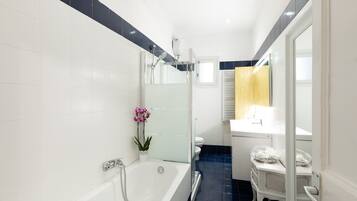 Bathtub, hair dryer, towels, soap