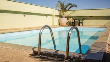 Outdoor pool, open 8:00 AM to 8:00 PM, pool loungers