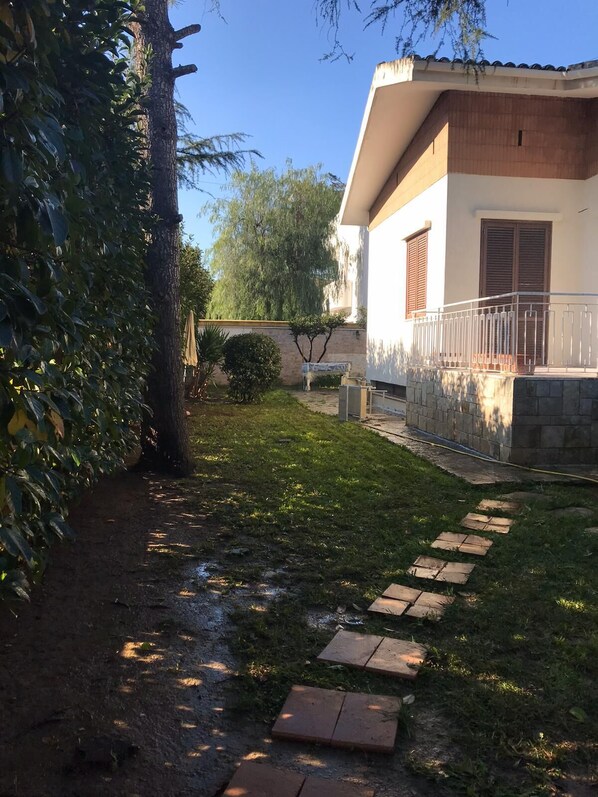 A residential property with a paved pathway leading to a house with a balcony. - Villa Susanna (Brindisi)