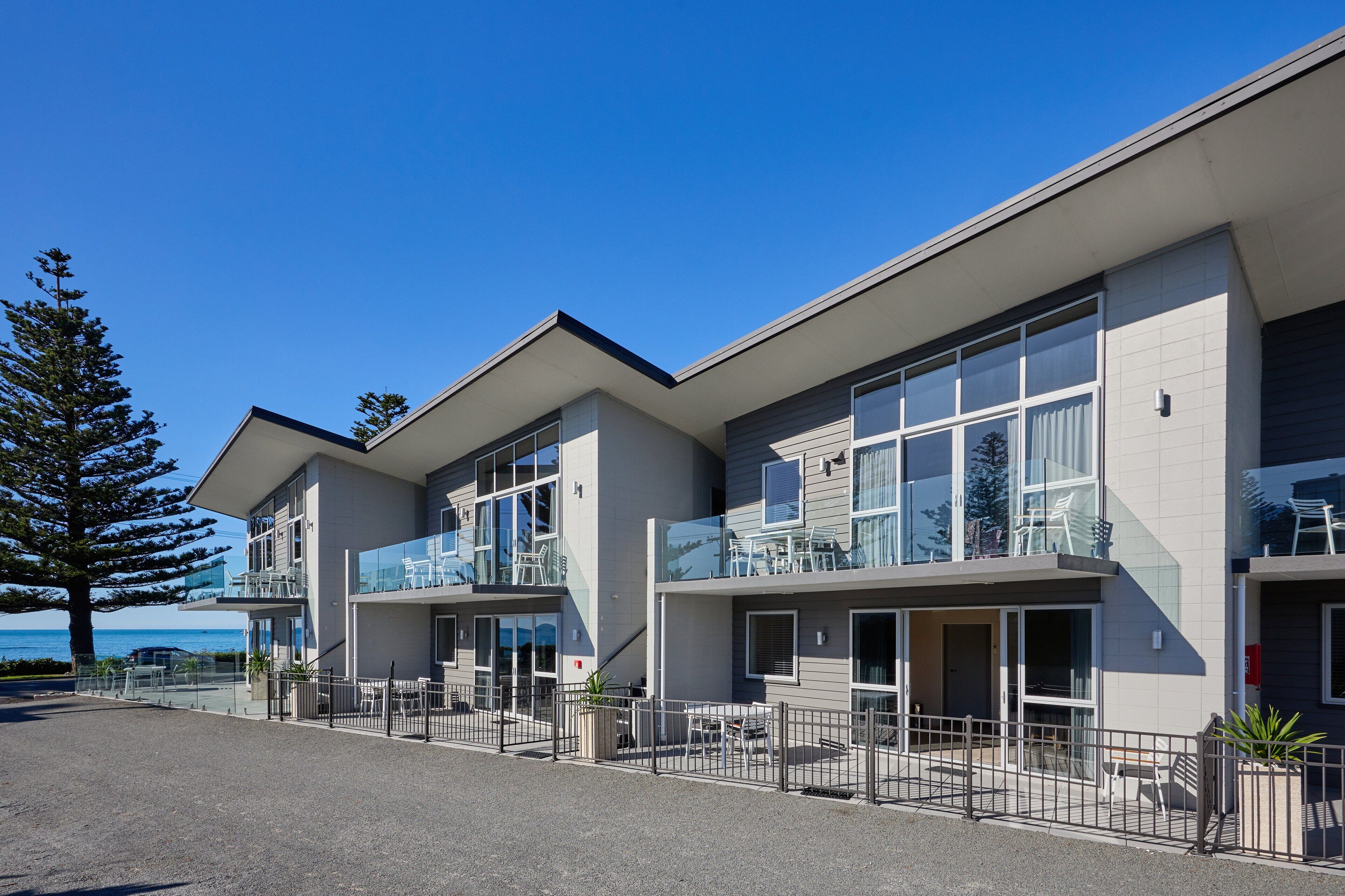 A modern building with multiple balconies and large windows, likely a hotel or apartment complex.