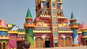 A colorful castle-like building with multiple towers and a central spire. - Pousada Morada Dos Anjos (Penha)