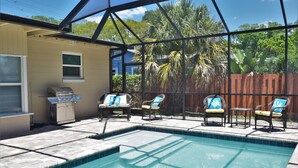 A backyard with a swimming pool, outdoor furniture, and a barbecue grill. - Arlington Park Area! Heated Pool 3 bedroom/ 2 bath (Sarasota)