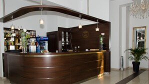 A reception desk with a wooden finish, a Pepsi refrigerator, and a mirror on the wall. - Hotel Zlotogorski (gmina Koscielec)